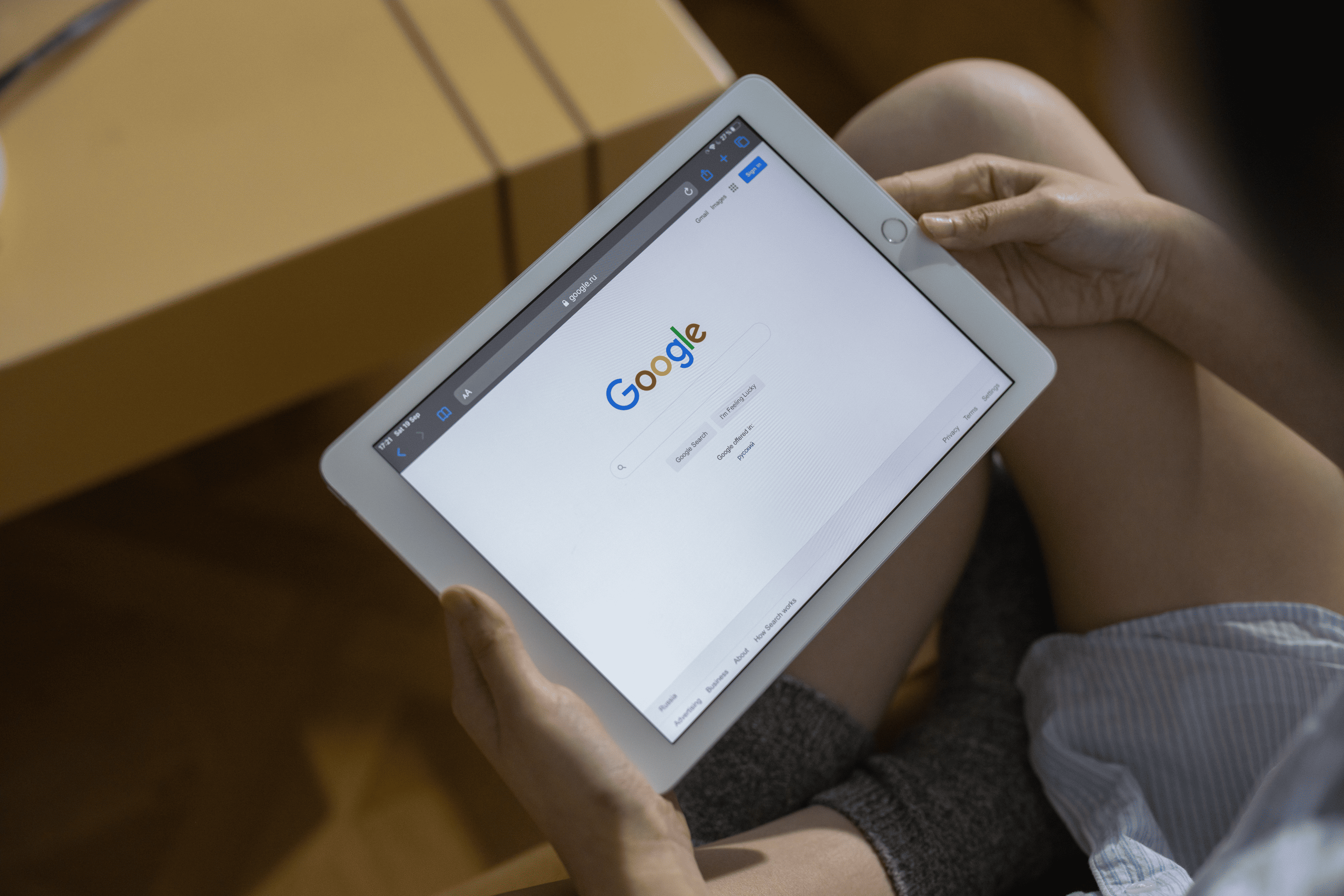 scrape google search results: a person touching a tablet with a google search engine page open